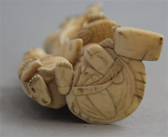 A Japanese ivory group of a woman carrying a basket of pomegranates, Meiji period, 16.8cm